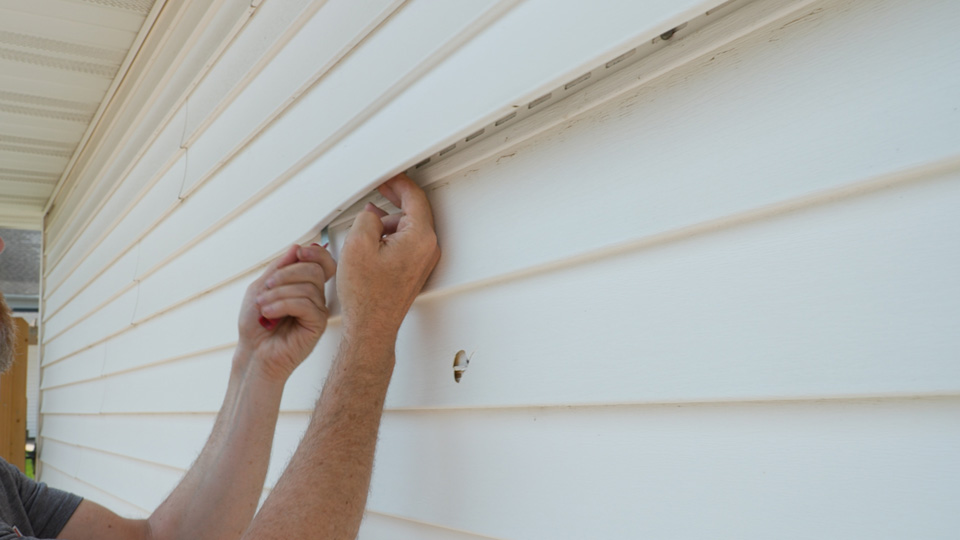using the siding removal tool on the entire panel